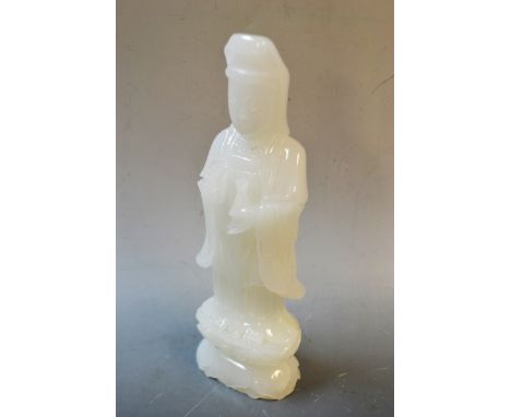 A carved white stone figure, Guanyin, possibly jade, 14.5cm high