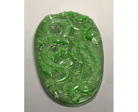 A large oval dark green jade dragon, phoenix and pearl of wisdom tablet pendant