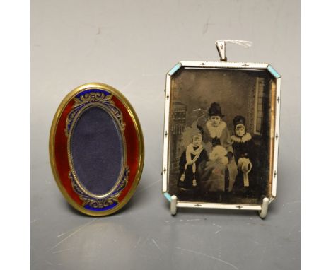 An Edwardian silver-gilt and enamel canted rectangular portrait miniature frame, the border decorated in tones of white and p