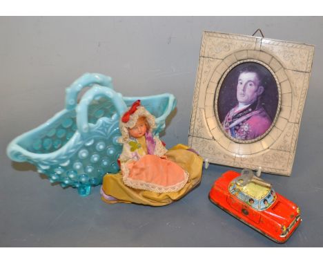 A wind up tin plate car; celluloid doll; blue glass basket; miniature print in an ivory effect frame