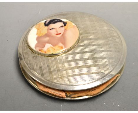A circular silver compact, inset with a raised panel, Art Deco Girl, stamped silver 883