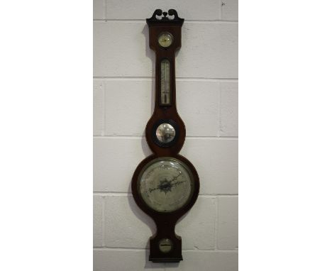 An early 19th century mahogany wheel barometer with silvered dials, hygrometer, alcohol thermometer, convex mirror and bubble