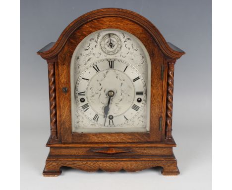 A George V oak mantel clock with eight day movement chiming quarters on four gongs and striking hours on a larger gong, the s