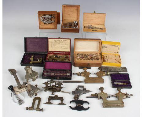 A collection of watchmaker's tools, including two poising tools and various depthing tools, together with various watch/clock