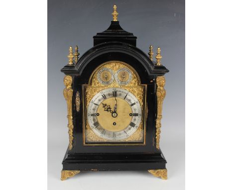 A late Victorian ebonized and gilt brass mounted bracket clock with eight day triple fusee movement chiming quarters on a nes