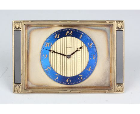 A French Art Deco gilt brass rectangular cased strut timepiece with eight day movement, the silvered dial with blue chapter r