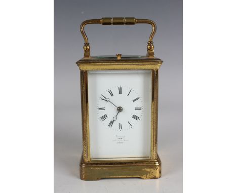 An early 20th century French lacquered brass cased carriage clock with eight day movement striking and repeating on a gong, t