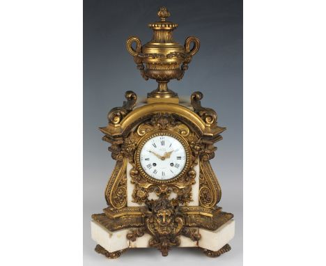 A late 19th century ormolu mounted white marble mantel clock with eight day movement striking on a bell, the enamelled circul