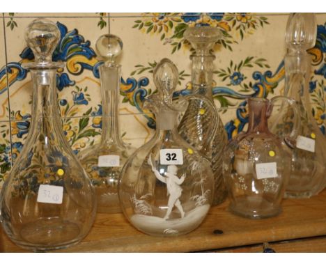Mary Gregory style enamelled decanter, 24cm, four other decanters and a water jug