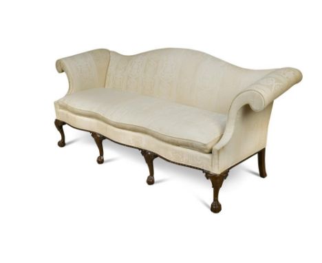 A George III style mahogany sofa, with serpentine shaped back and seat, out-scrolling arms, upholstered in a cream damask fab