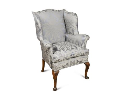 A small George III style wing back armchair, upholstered in a blue damask fabric, loose cushion seat, on mahogany cabriole le