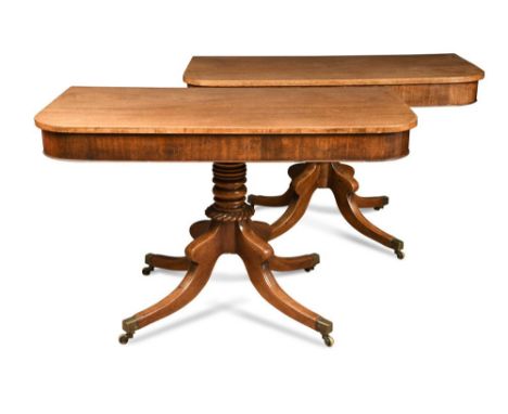 A pair of Regency mahogany D-end pedestal console tables, on turned and gadroon moulded columns, on hipped and swept legs wit