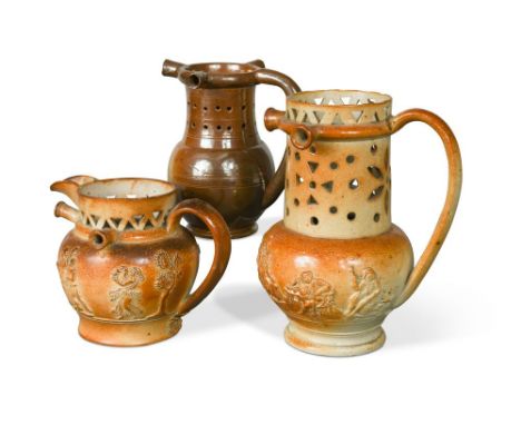 A 19th century Derbyshire salt glazed pottery puzzle jug, typically modelled and sprigged with figures drinking and smoking a