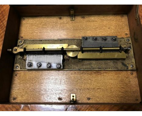A 19th century walnut and rosewood German disc musical box, with later 'Symphonion' card to the lid underside, twin 11.5cm co