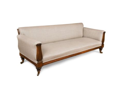 A late Regency rosewood sofa, upholstered in a grey linen fabric, with lapit carved show-wood, on turned legs and large brass