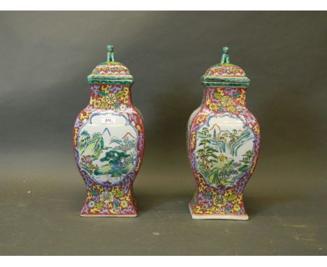 A pair of Chinese famille rose porcelain jars and covers with enamel decoration depicting figures in a landscape, the lids wi