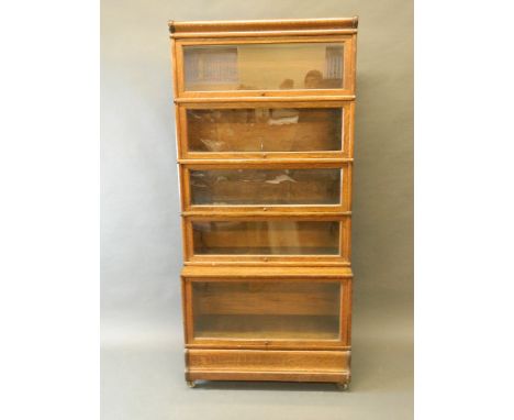 A 1930s five section oak Globe-Wernicke bookcase with stepped lower section, bears label, 34'' x 13'', 73'' high