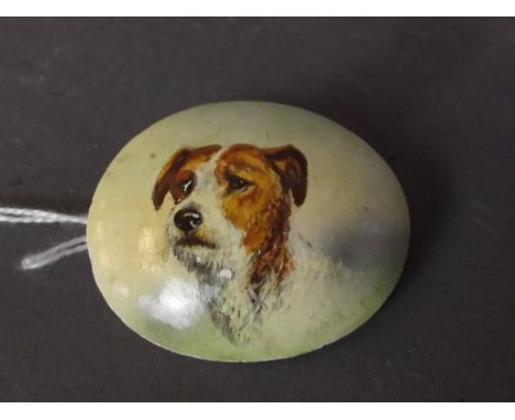 An early C20th oval shaped brooch with fine enamel painting of a terrier's head, 1¾'' long
