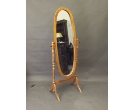 A light wood oval shaped cheval mirror, 59'' x 20½''