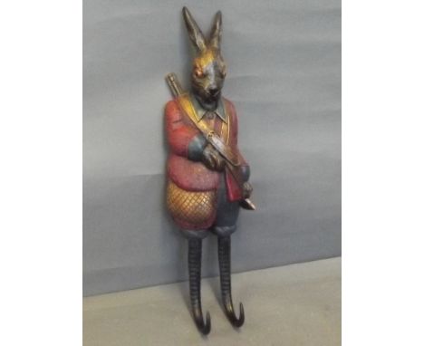 A painted composition coat hook in the form of a hunting hare, 19'' long