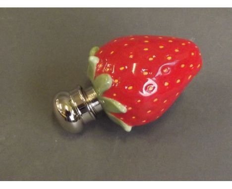 A ceramic perfume bottle in the form of a strawberry with a silver plated lid, 2'' long