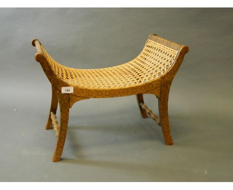 An Edwardian beech 'Thebes' stool with incised decoration and caned seat, 20'' x 11½'', 15'' high