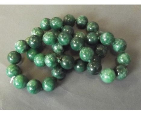 A heavy jade bead necklace, 26'' long