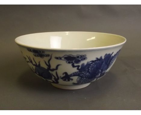 A fine Chinese blue and white porcelain bowl with painted decoration of dragons chasing the flaming pearl, 6 character mark, 