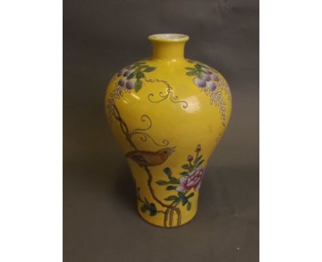 A Chinese yellow ground crackleglaze baluster vase with painted enamel decoration of birds, lotus flowers and fruiting vines,