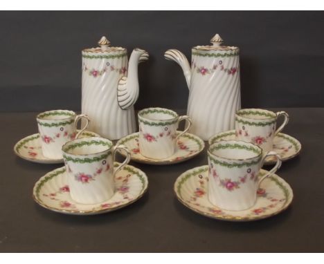 An English part coffee set decorated with flower swags, comprising two coffee pots, five cups and five saucers, 6½'' high (AF