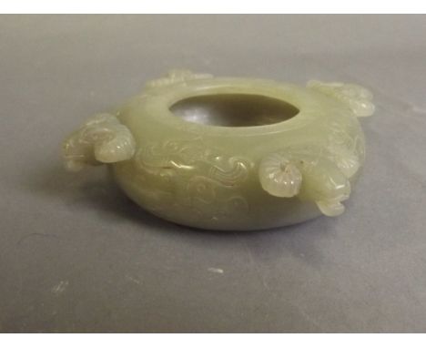 A Chinese celadon jade brush wash with carved ram's head decoration, 4'' diameter