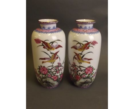A pair of Chinese porcelain vases with gilt rims and painted enamel decoration of exotic birds and lotus flower, marked, 8'' 