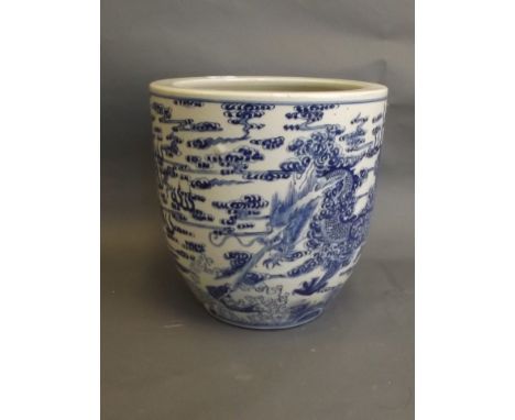 A Chinese blue and white porcelain jardinière with painted decoration of a water dragon chasing flying fish and the flaming p