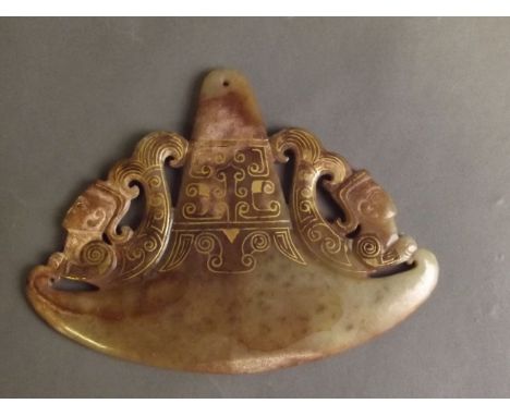 A Chinese green and brown jade ceremonial pendant with gilt and carved Archaic decoration, 5½'' long