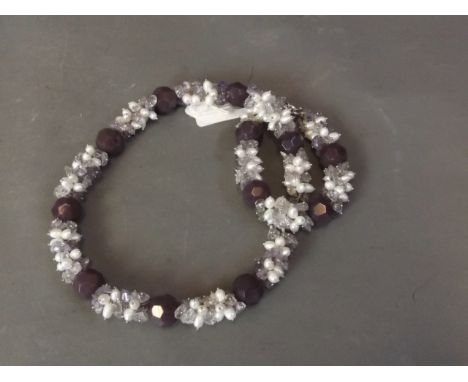 An amethyst coloured crystal glass and pearl necklace with matching bracelet