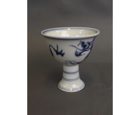 A Chinese blue and white porcelain stem cup with painted decoration of a dragon chasing the flaming pearl, 6 character mark, 