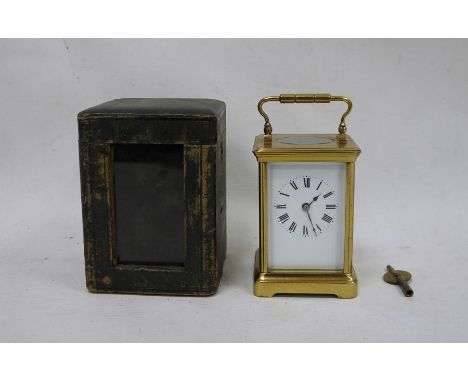 Brass and glass carriage clock with Roman numerals to the dial, in leather carry case