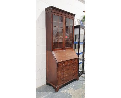 19th century mahogany bureau bookcase, the moulded cornice above astragal glazed doors enclosing shelves, the base of four lo