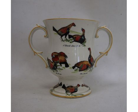 Ceramic two-handled trophy cup decorated with fighting birds 'A Challenge', 'A Knock Down Blow', etc, 17cm high 