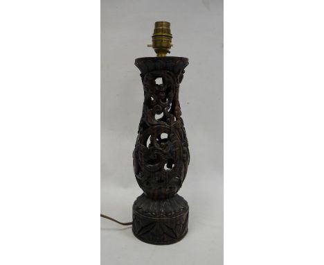 Eastern carved and pierced hardwood table lamp with figure of a dancer accompanied by a fawn, 29cm high (excluding fittings) 