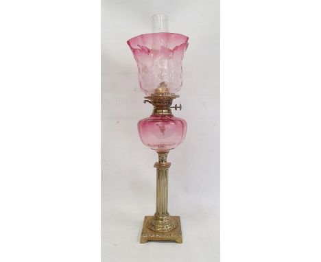 Cranberry and brass oil lamp having panelled flared shade, cranberry well, on reeded column, square baseCondition ReportPolis