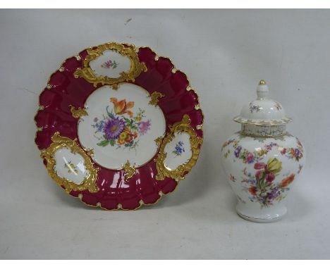 Circular floral and gilt decorated dish with blue cross swords mark to reverse, 30cm high and a floral lidded vase, 26cm high