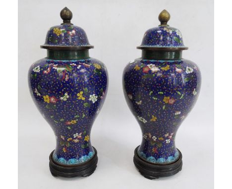Pair Chinese cloisonne enamel inverse baluster vases, each with high domed cover and allover scrolling floral decoration on a