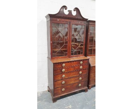 George III mahogany secretaire bookcase with swan-neck pediment above astragal glazed doors enclosing adjustable shelves, the