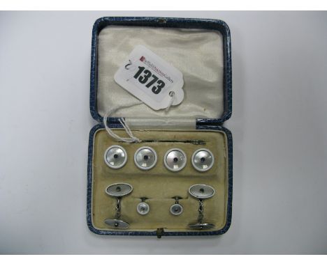 A Mother of Pearl and Enamel Gent's Dress Set, highlighted in white enamel, comprising cufflinks, dress studs and buttons, in
