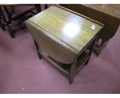 A 1930's Oak Tea Trolley, with drop leaves, single drawer, on square supports with under shelf.