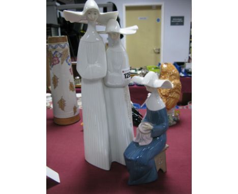 A Lladro Porcelain Model of a Seated Nun, with an embroidery, printed and pressed marks, 22cm high and another of two nuns in