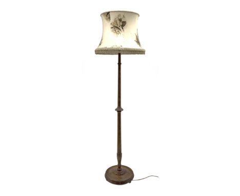 Early 20th century oak standard lamp, tapered column with bead and carved decoration, on a circular moulded platform base, wi
