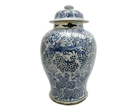 18th century Chinese porcelain jar and cover, of baluster form painted in underglaze blue with phoenix amongst stylised fruit