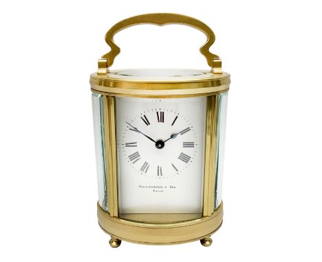 Late 20th century carriage timepiece clock, polished brass case of oval form glazed with bevelled glass panels, white enamel 